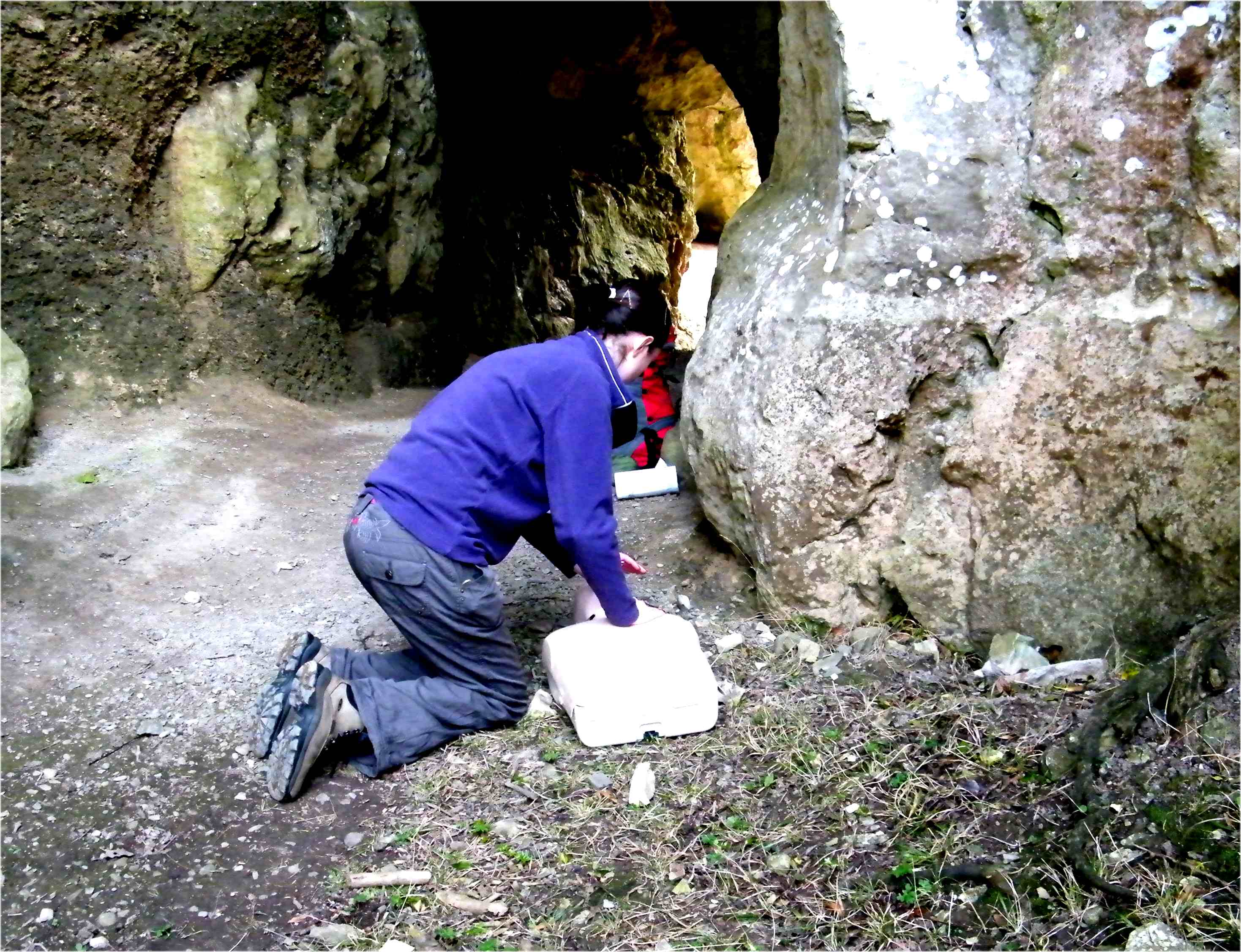 Practicing CPR in the entrance to a cave